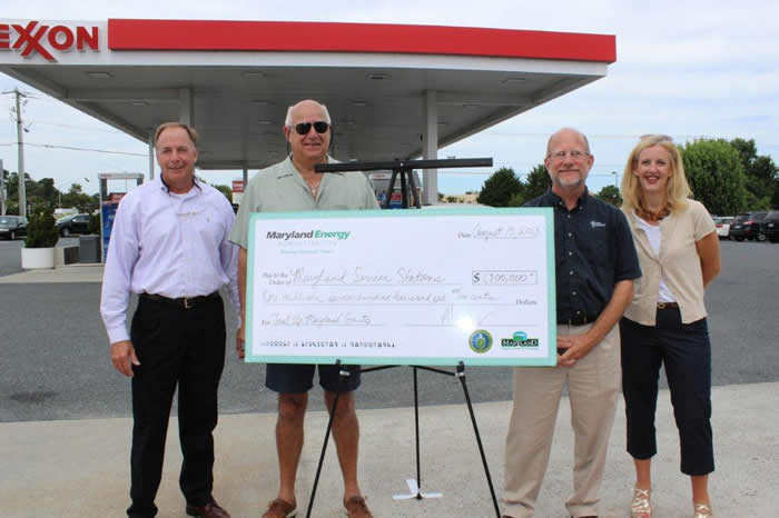 (Right to left): Abby Ross Hopper, Director of the Maryland Energy Administration formally announces the Service Station Energy Resiliency Grant Program and presents a symbolic check for $1.7 million to Maryland service stations. Representing service stations across the State was Jamie Brooke of WMDA (far left), as well as the Exxon station owners Ed Ellis and Steve Ladd of Ocean Petroleum.