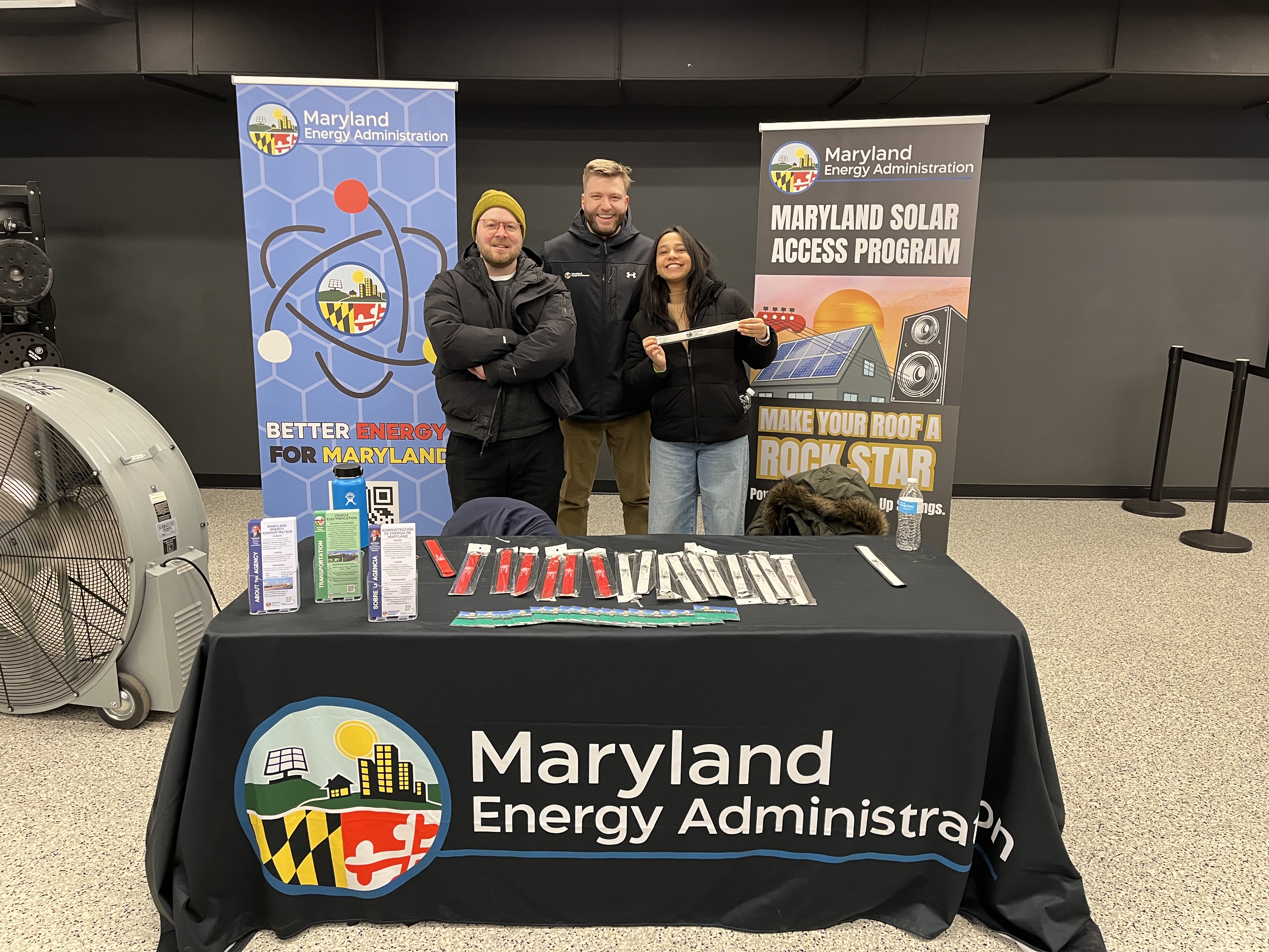 a group of coworkers standing behind a table